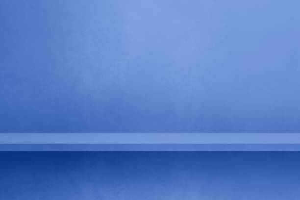 istock Empty shelf on a lilac blue concrete wall. Background template. Horizontal mockup 1487665910