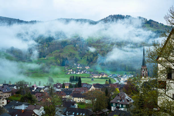 istock Clouds over the valley and village in Schwarzwald , Germany at dusk 1487666192