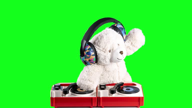 Teddy bear djing on turntables with headphones