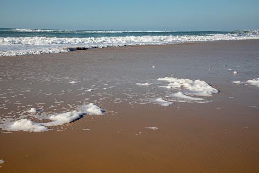 foam on sea beach soft wave with bubbles on sand coast