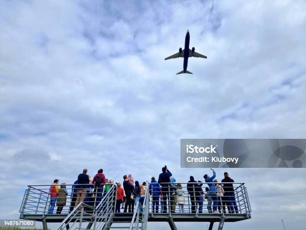 Group Of People Watching An Airplane Taking Off Stock Photo - Download Image Now - Airplane, Spotting - Weight Training, Katowice