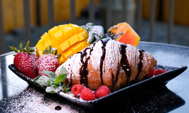 delicious french breakfast croissant with chocolate and powdered sugar morning in hotel breakfast in cafe chocolate drips down on the balcony sit watch advertisement menu order online delivery
