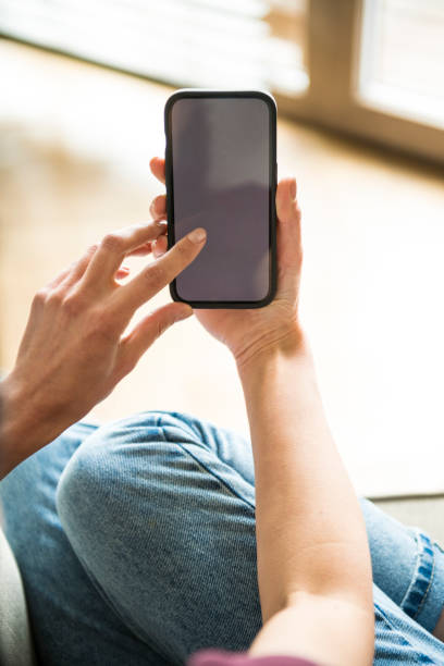 istock A woman hand holding a mobile phone with blank screen 1487673886