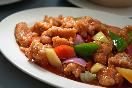 Cantonese dish sweet and sour pork served at Chinese restaurant