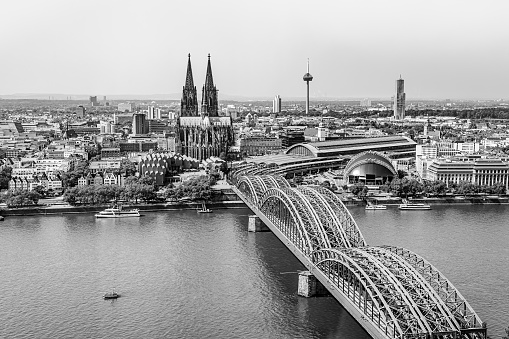 Cologne, Germany: Beautiful panoramic aerial landscape of the gothic catholic Cologne cathedral, Hohenzollern Bridge and the River Rhine in black and white