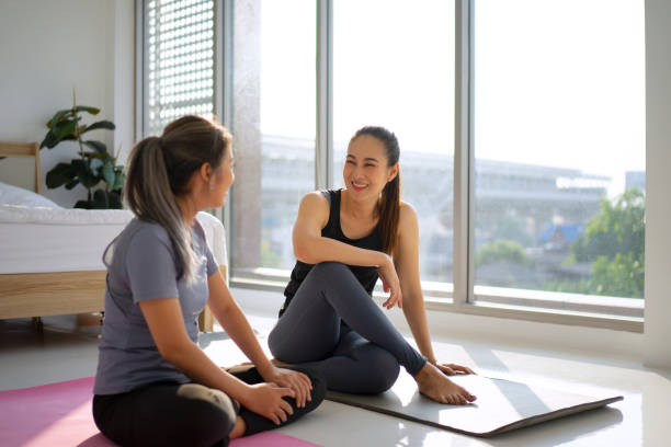 istock Women play yoga at home. 1487675568