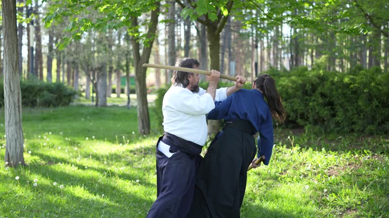 Aikido couple participants of the training in special clothes of aikido at outdoor