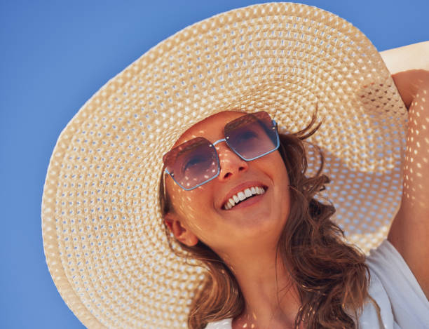 istock Image of young woman in hat over blue sky 1487677313