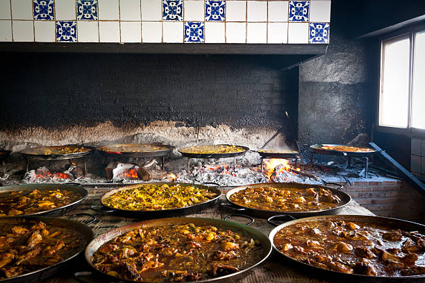 Valencian paella cooking on log fire