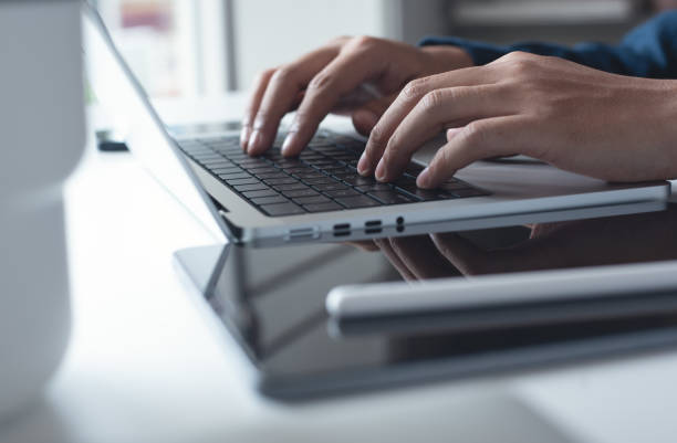 istock Businessman working on laptop computer at home office. Casual business man, freelancer using portable computer devices, surfing the internet networking on table at workplace 1487681121