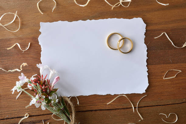 istock Gold rings on rustic wooden table and white isolated background 1487682804