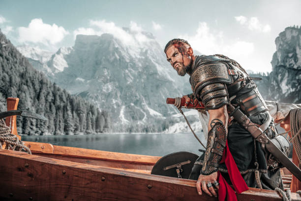 istock Viking Warrior sailing on a fjord on an authentic viking long boat 1487683021