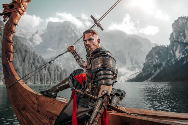 istock Viking Warrior sailing on a fjord on an authentic viking long boat 1487683022