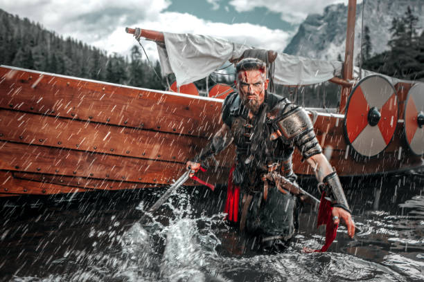 istock Viking Warrior sailing on a fjord on an authentic viking long boat 1487683065