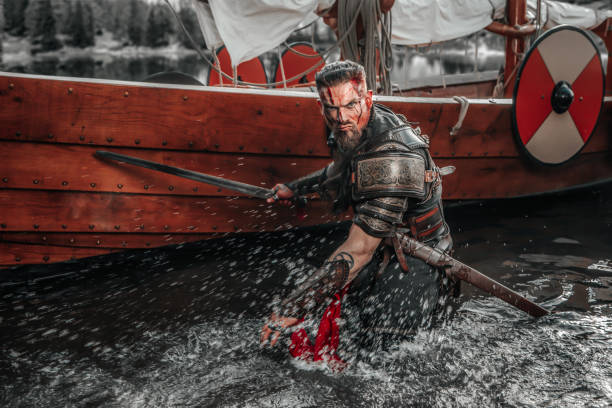 istock Viking Warrior sailing on a fjord on an authentic viking long boat 1487683068