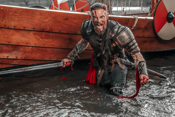 istock Viking Warrior sailing on a fjord on an authentic viking long boat 1487683075