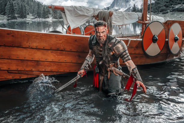 istock Viking Warrior sailing on a fjord on an authentic viking long boat 1487683088