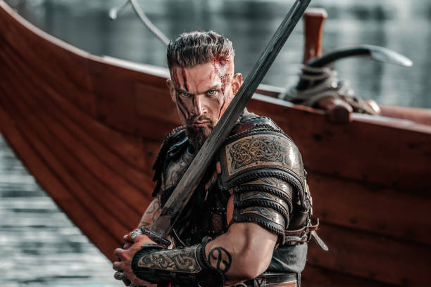 istock Viking Warrior sailing on a fjord on an authentic viking long boat 1487683095