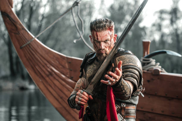 istock Viking Warrior sailing on a fjord on an authentic viking long boat 1487683096