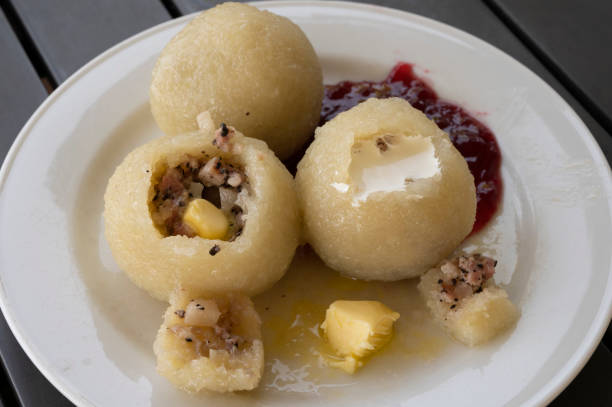 Traditional Swedish boiled potato dumplings from Öland, most commonly filled with onions and pork meat. Usually served with melted butter, lingonberry jam. In this case there is also a generous serving of heavy cream.