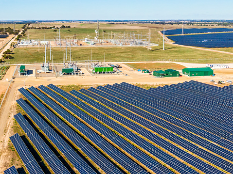 Harvesting the sun: aerial view large solar energy farm with electrical substation, distribution & communications equipment and associated buildings near Tailem Bend, South Australia