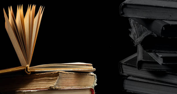 istock Stack of hardcover old books with an open book on a dark background. Bookshelf shop, Knowledge publications, literature. Bookish bookstore bookstore 1487688355