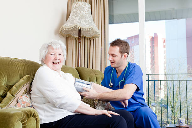 Nurse checking senior ladys blood pressure