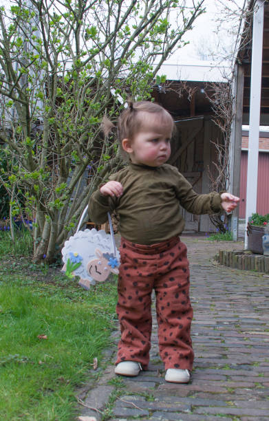 Family event at Easter and baby grandchild  is searching for eggs