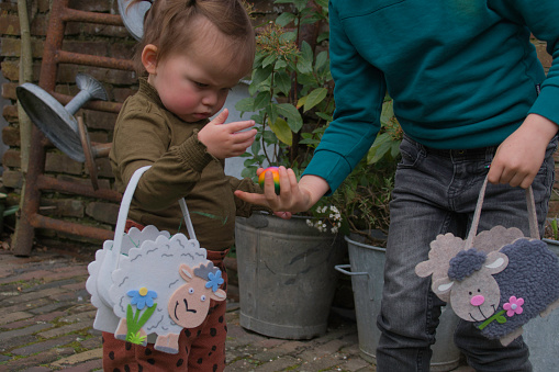 Family event at Easter with Toddler grandchildren  are searching for eggs