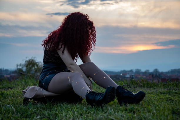 istock Young woman sitting on grass 1487692742