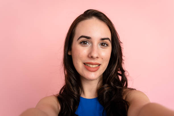 istock Beautiful brunette woman on pink background. 1487694320