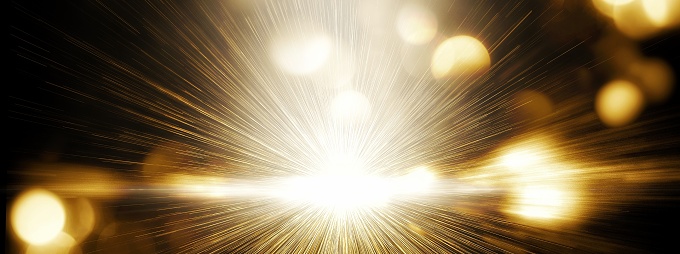 Abstract background of golden rays shining in the night sky in energy concept