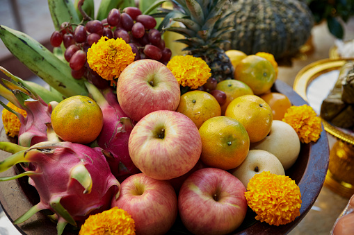 The variety of fruits decoration with marigold flower on plate