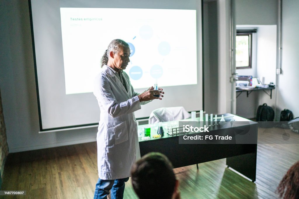 Teacher doing a presentation during chemistry class Instructor Stock Photo
