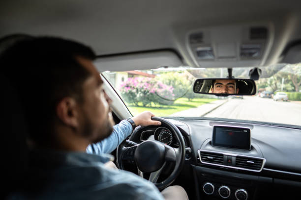 istock Young man talking and through the car rear view 1487703688