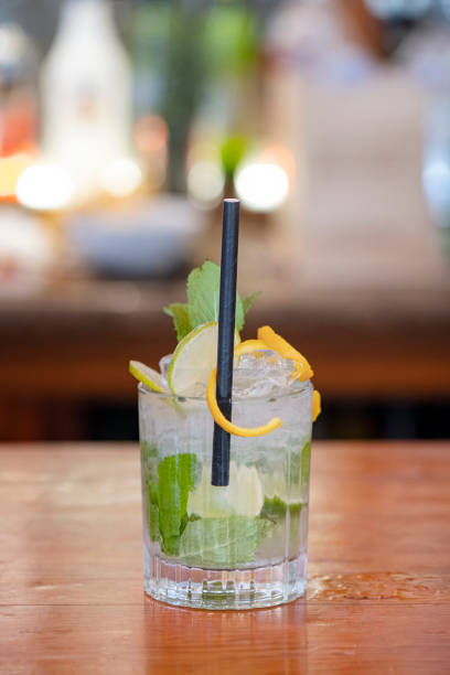 istock Mojito cocktail set on a bar table, refreshing alcoholic beverage originated in Cuba 1487703980