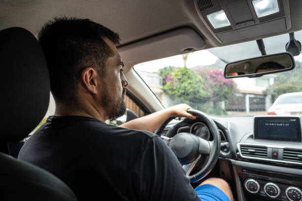 istock Young man driving in a car 1487704193