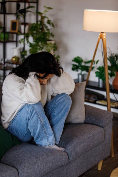 istock Distraught young woman sitting with head in hands, struggling with negative emotions 1487704232