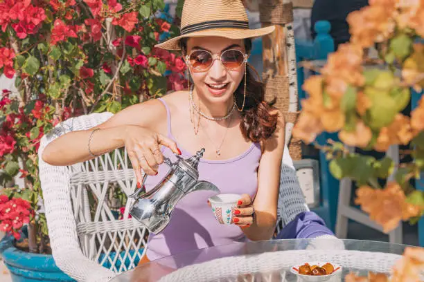 Photo of Through the experience of enjoying Arab coffee in a traditional cafe in Dubai, a girl tourist gains a deeper appreciation for the warmth and hospitality of Emirati culture.