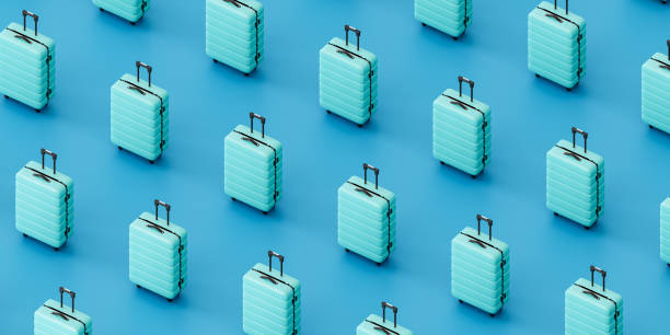 Similar blue suitcases against blue background. 3d render isometric view stock photo