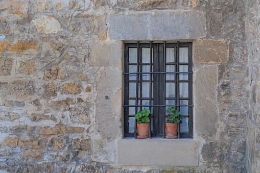 stone facade of a rural house with window. old stone cottage in the north of Spain