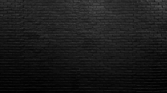 black brick wall texture for pattern background. architectural wide panorama brick work wall for rustic, industrial, loft design. close up view of building facade wall.