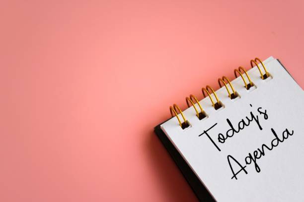 istock Notebook with text TODAY'S AGENDA on pink background 1487710935