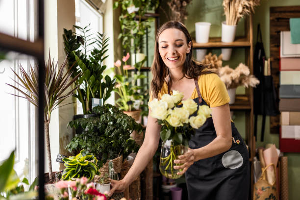 istock Happy flower vendor woman is working 1487711251