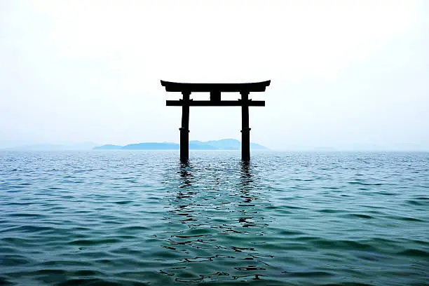 Silhouette of japan gate on the lake water.