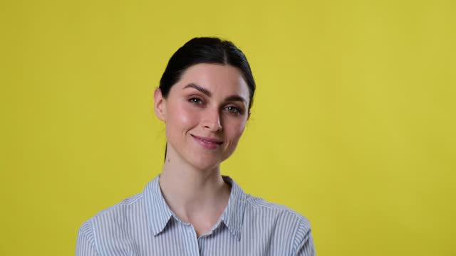 Portrait of Smiling Caucasian Woman over Yellow Background