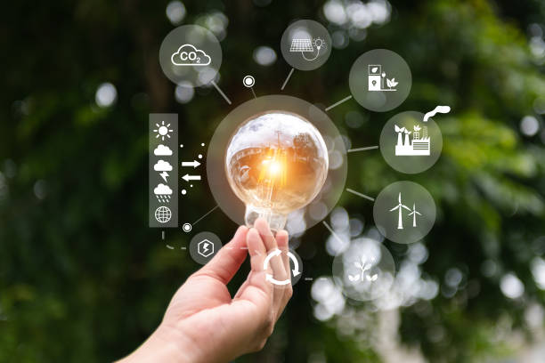 istock Hand holding light bulb with green background. idea solar energy in nature concept in virtual icon 1487713316