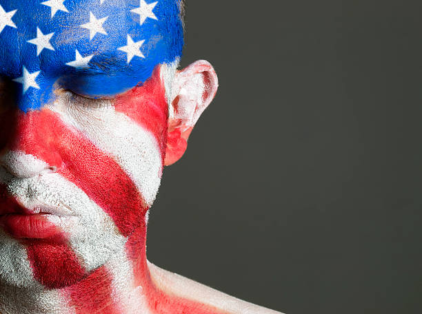 istock Man face painted flag USA, eyes closed. 148771482