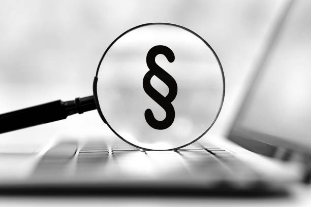 istock black paragraph character in magnifying glass on laptop keyboard 1487715093