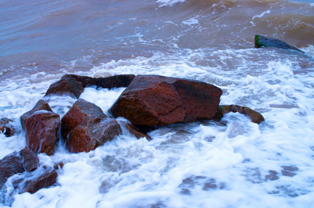 coastal stones in the surf, bubbling water